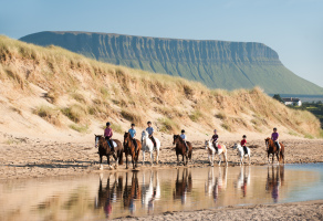 Students Horse Riding on the Beach