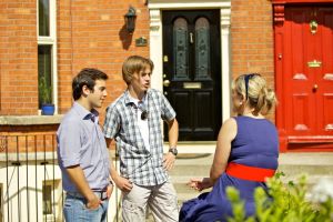 Host Family Mother speaks to Two Students in the Garden